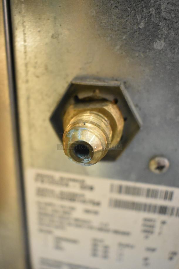 2023 Scotsman FS1222A-32B Ice Head, stainless steel, 208/230V, 1 phase, commercial use. Close-up of rear valve and label.