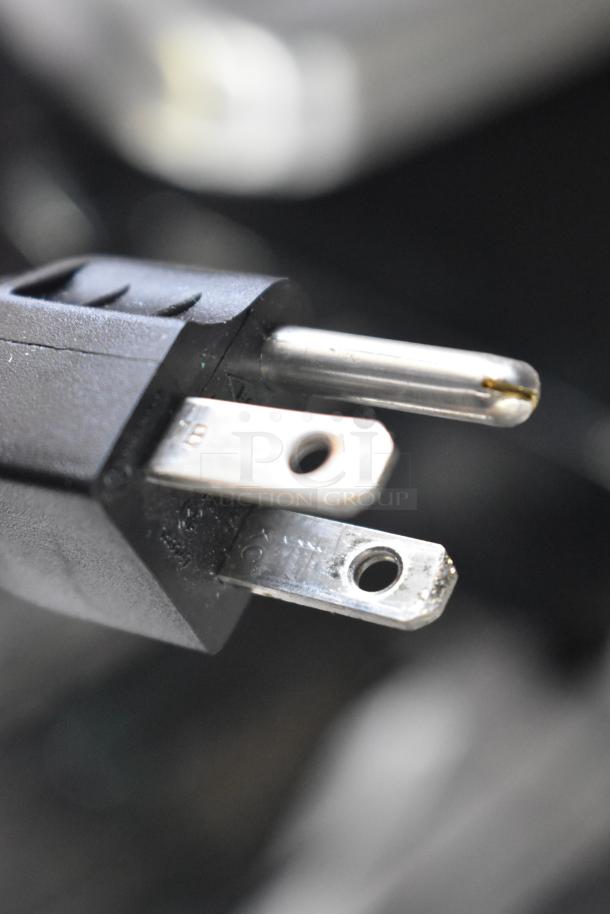 Close-up of a power plug for the 2017 Hobart HTi-7LH26 metal countertop scale with label printer, 120/208-240 volts, 1 phase.