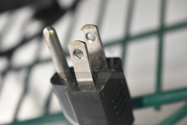 Close-up of a three-prong electrical plug compatible with the 2023 Hobart HTi-7LH4W Metal Countertop Scale.