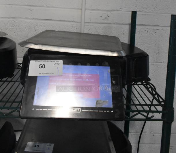 2017 Hobart HTi-7LH26 metal countertop scale with label printer, tested and working. Features digital display, slight wear.