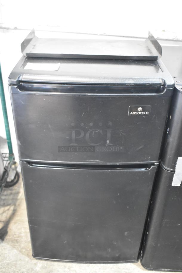 Absocold ARD298CB10R mini cooler with freezer, black, 115 volts, 1 phase. Features Absocold label. Good condition.