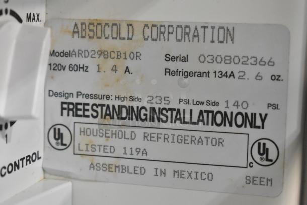 Absocold ARD298CB10R Mini Cooler label showing specs: 120V, 1.4A, refrigerant 134A, UL certified, assembled in Mexico.
