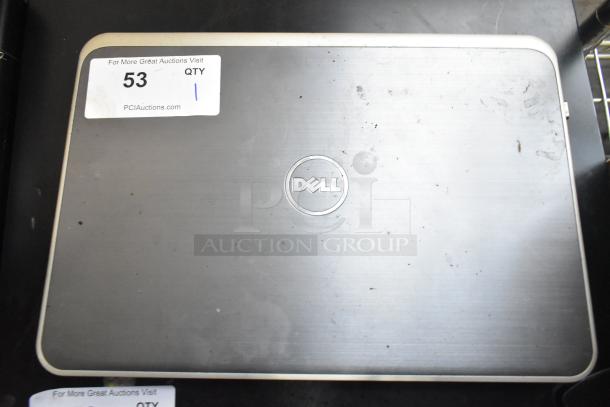 Dell Inspiron 15R-5537 Laptop with charger, silver finish. Visible scratches and sticker on the lid. Auction label "53, QTY 1".