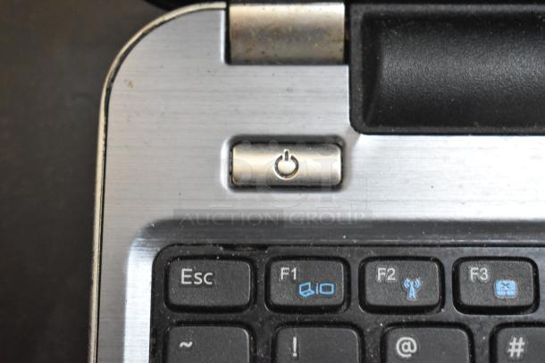 Dell Inspiron 15R-5537 laptop, showing a close-up of the power button and keyboard. Condition appears used.
