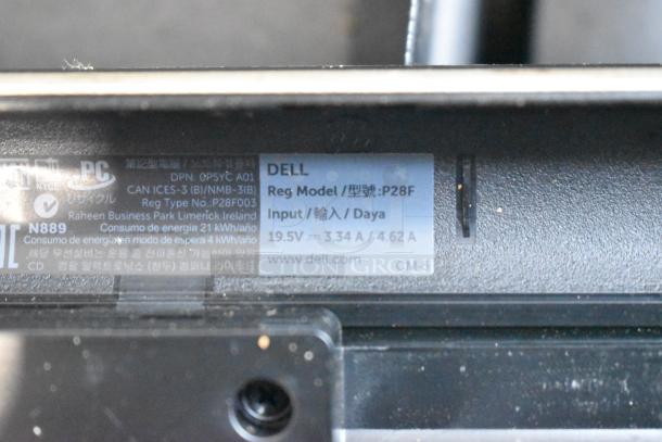 Dell Inspiron 15R-5537 laptop label showing model P28F, input power 19.5V, 3.34A/4.62A, includes charger.