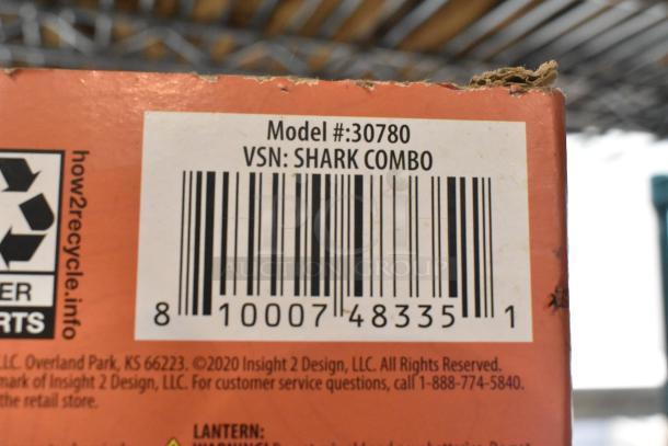 Barcode close-up image showing Model #: 30780, VSN: SHARK COMBO. Corner of the packaging is slightly worn.