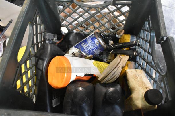 Assorted items in a black crate, including various containers, a Husky tool, and a can. Mixed condition, ideal for all-purpose use.