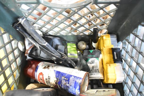 Tier lot including assorted items like a Ryobi saw, Marlboro pack, and yellow tool case. Mixed condition.