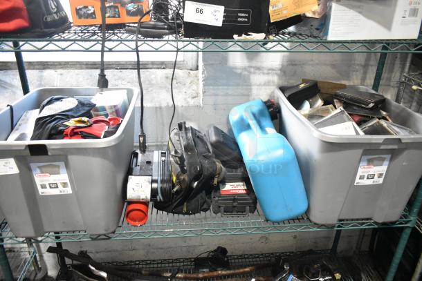 Various items in storage bins, including a portable DVD player, DVDs, tools, and a blue Amerex fire extinguisher.