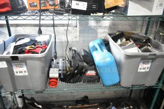 Various items in storage bins, including a portable DVD player, DVDs, tools, and a blue Amerex fire extinguisher.