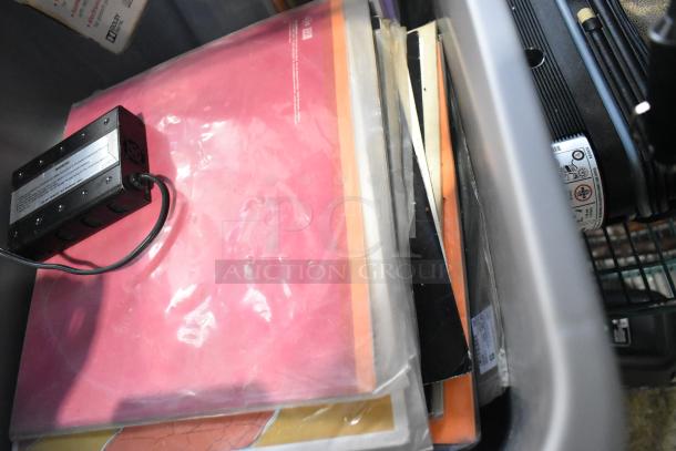 A tier lot of various items includes a portable DVD player, DVDs, markers, tools, and an Amerex fire extinguisher.