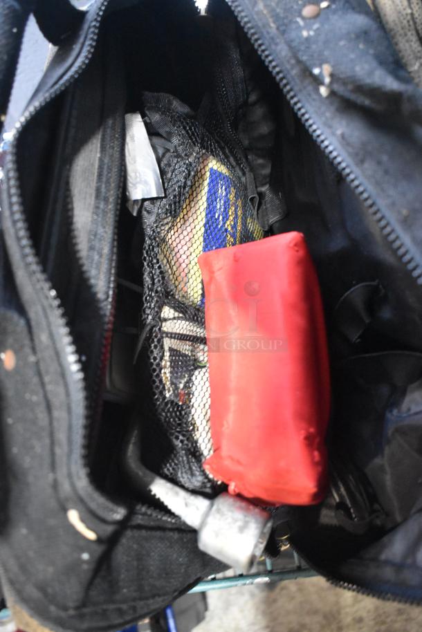 Bag containing a portable DVD player, DVDs, markers, tools, and Amerex fire extinguisher. Items appear used.