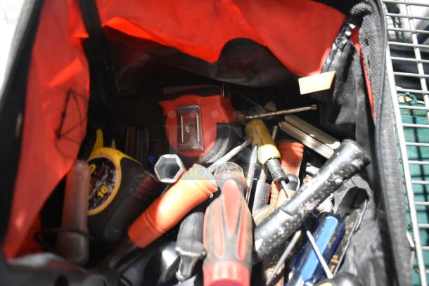 Auction item: Tool bag with assorted tools, tape measure, Permatex gasket maker, first aid kit, HWStar LED headlights.