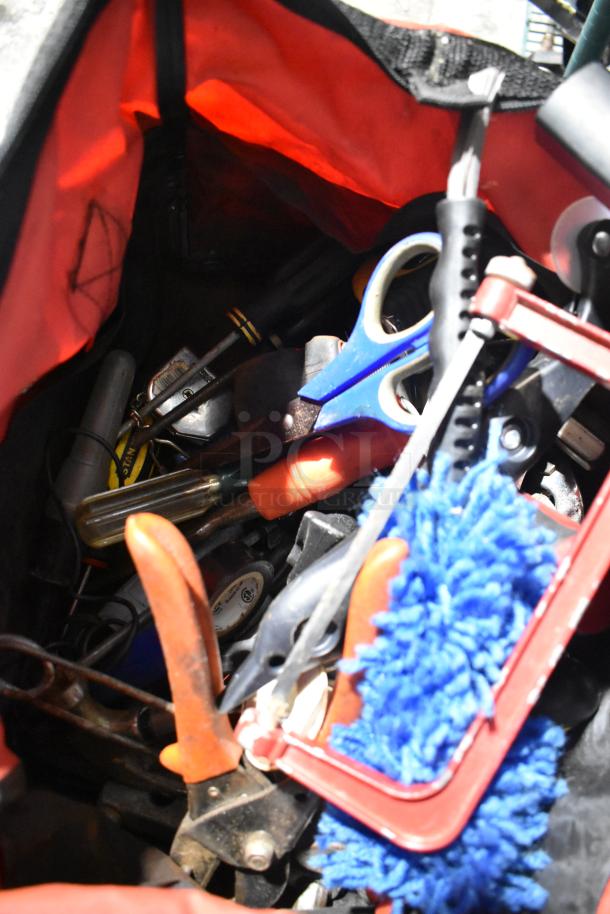 Lot includes a tool bag filled with various tools, Permatex gasket maker toy, first aid kit, HWStar LED headlights. The condition appears used. Tags and labels are not visible.