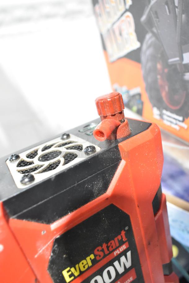 EverStart Plus 1000W power inverter with visible fan vent and red cap in used condition. Background shows packaging.