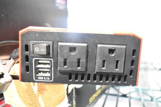 Power inverter with dual AC outlets and USB 3.1A ports. Includes an on/off switch. Slight wear visible.