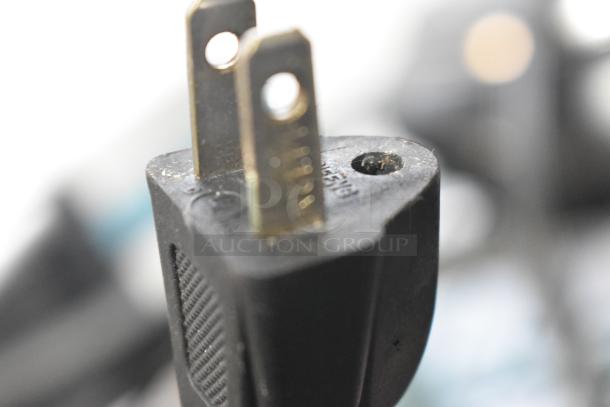 Close-up of a power plug, possibly part of the Olaf waffle maker or 2 burner range. Black plastic, slightly worn condition.