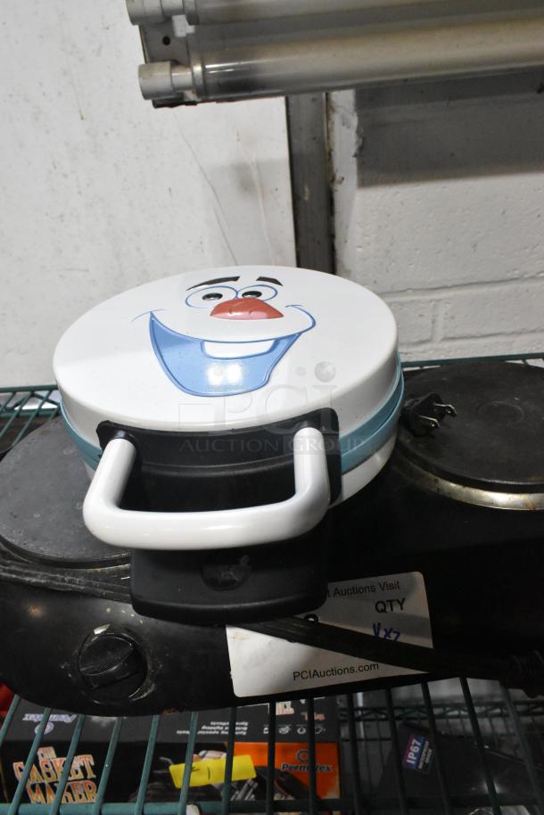 Olaf-themed waffle maker and 2-burner range, used condition. Waffle maker features Olaf's face, compact design; range includes two burners.