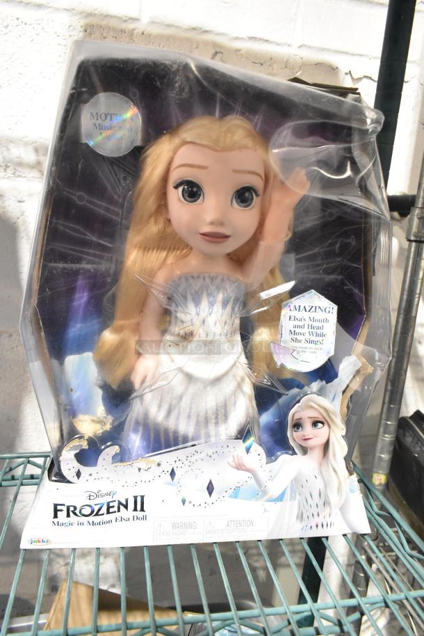 Disney Frozen II Magic in Motion Elsa doll, new in box, features singing and head movement. Box shows minor wear.