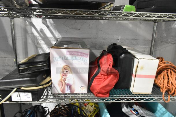 Tiered lot with various items: Sparkle the Unicorn Kid's Camping Set, red Jeep bag, black case, and Westward power source, all on shelf.