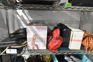 Tiered lot with various items: Sparkle the Unicorn Kid's Camping Set, red Jeep bag, black case, and Westward power source, all on shelf.