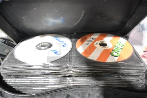 Image of a CD wallet containing various discs, one labeled "Juno" and another handwritten with "Pinatsu," part of a mixed item auction lot.