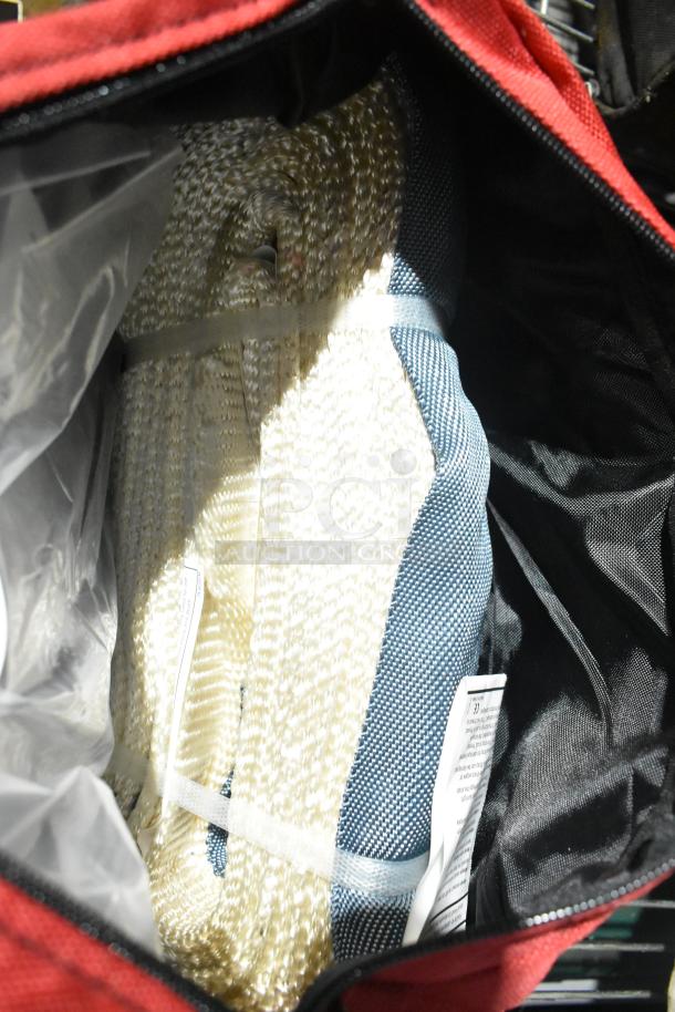 Alt text: Inside view of a red bag containing coiled rope and a blue mesh item, part of a mixed auction lot.