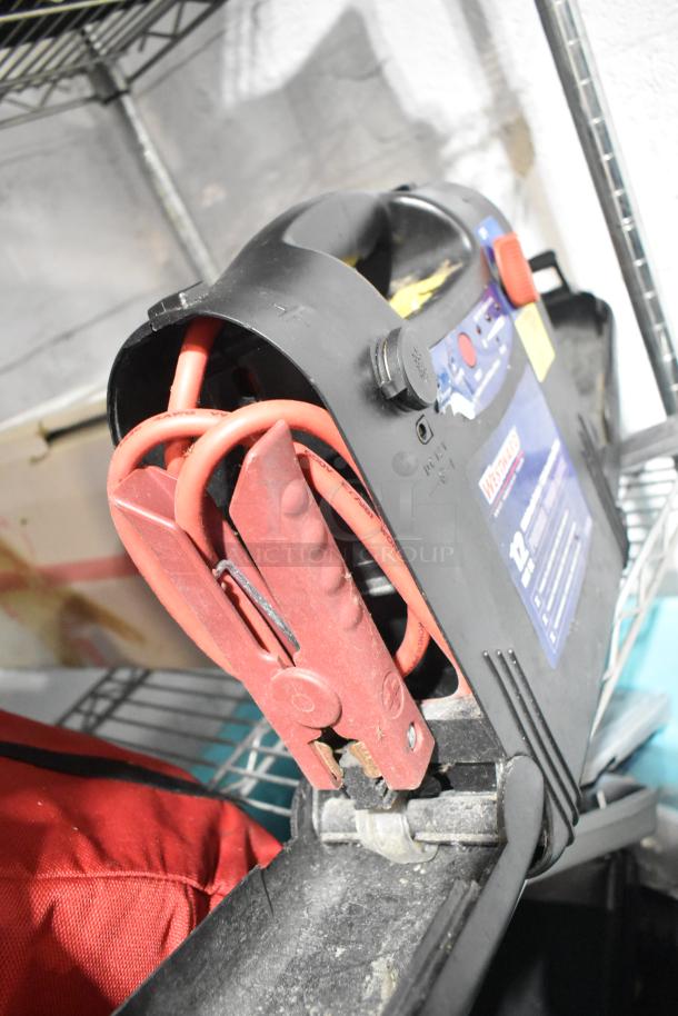 Westward power source with red jumper cables, model label visible. In used condition, part of a tier lot including various items.