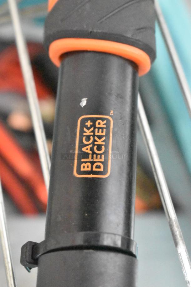 Black+Decker tool handle, black and orange, with slight wear. Label shows brand name and logo clearly.