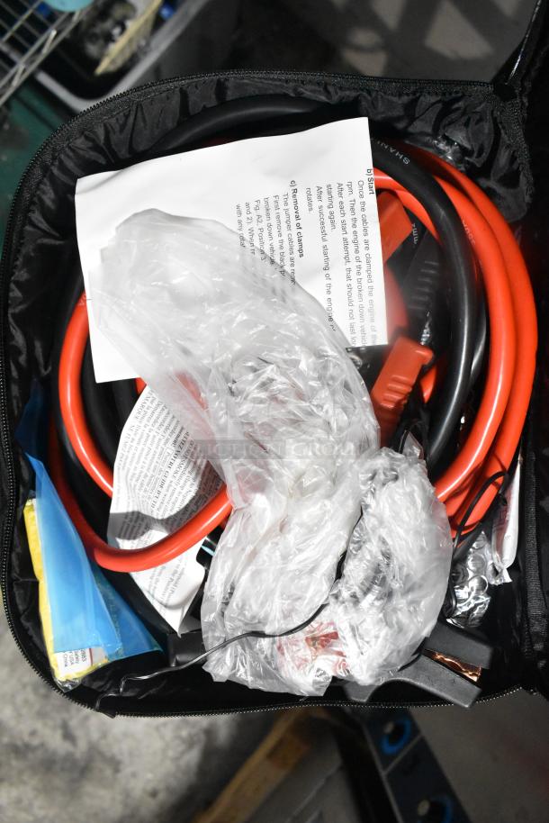 Mixed items including cables, plastic bags, and documents in a black zippered bag. Auction lot, assorted contents.
