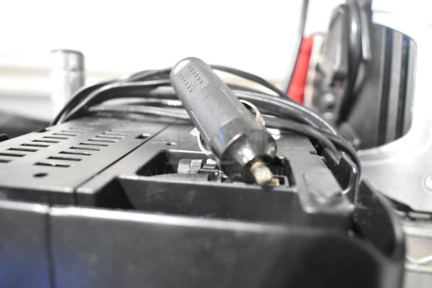 A black Jensen radio with visible power plug and cable, in used condition. Auction includes two items.