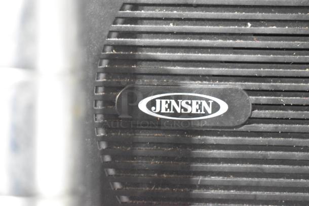 Jensen radio close-up with logo, black grille, and horizontal slats, possibly in used condition.