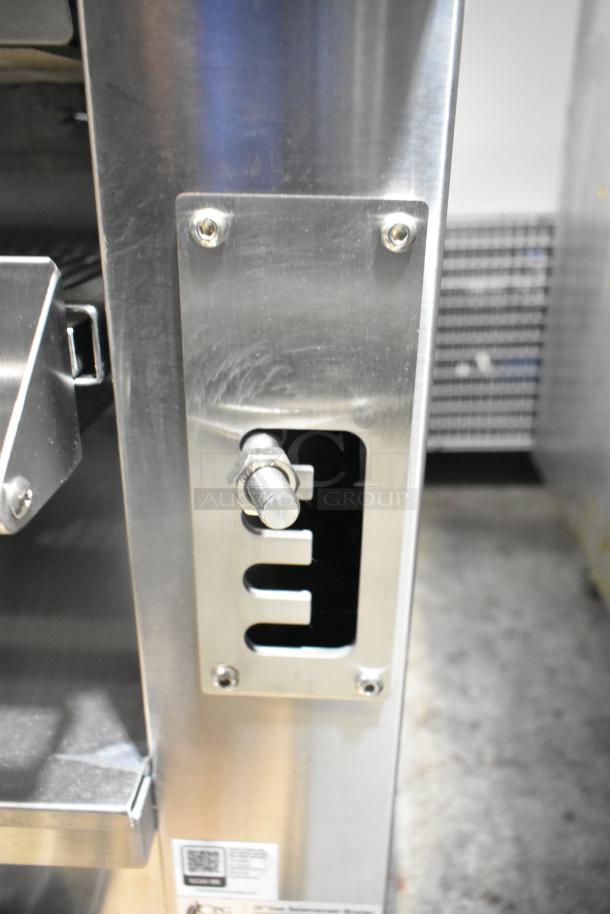 Stainless steel control panel of Cooking Performance Group 351S36SBN salamander broiler. Features vents and adjustment knob.