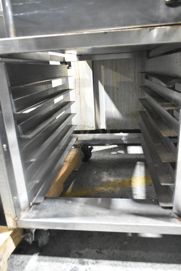 Baxter OV310E stainless steel commercial electric mini rotating rack oven on double pan rack, visible compartments.