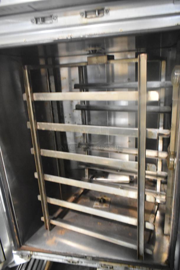 Baxter OV310E stainless steel commercial mini rotating rack oven, electric-powered, on double pan rack, visible scuff marks.