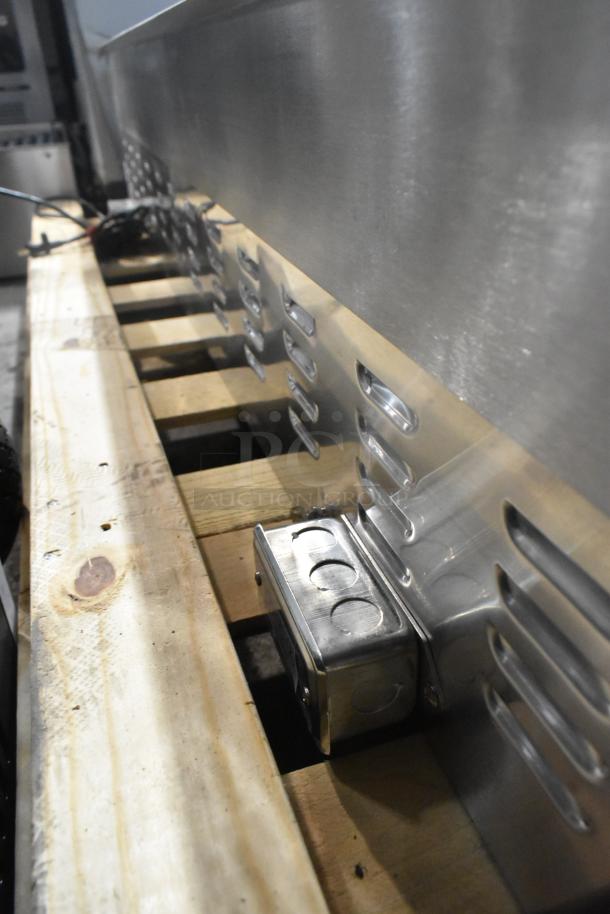 Brand new Avantco stainless steel commercial griddle, scratch and dent, with thermostatic controls on wood pallet.