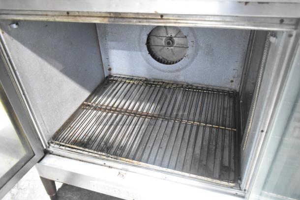 Blodgett stainless steel commercial convection oven with view-through doors, metal racks, and thermostatic controls.