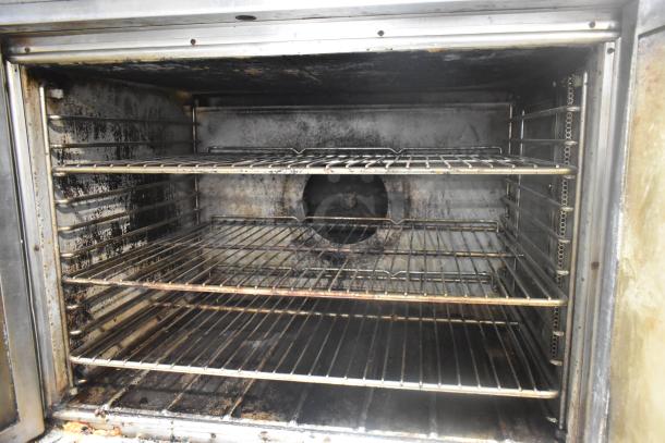 Blodgett stainless steel commercial convection oven with view-through doors, featuring metal oven racks and thermostatic controls.