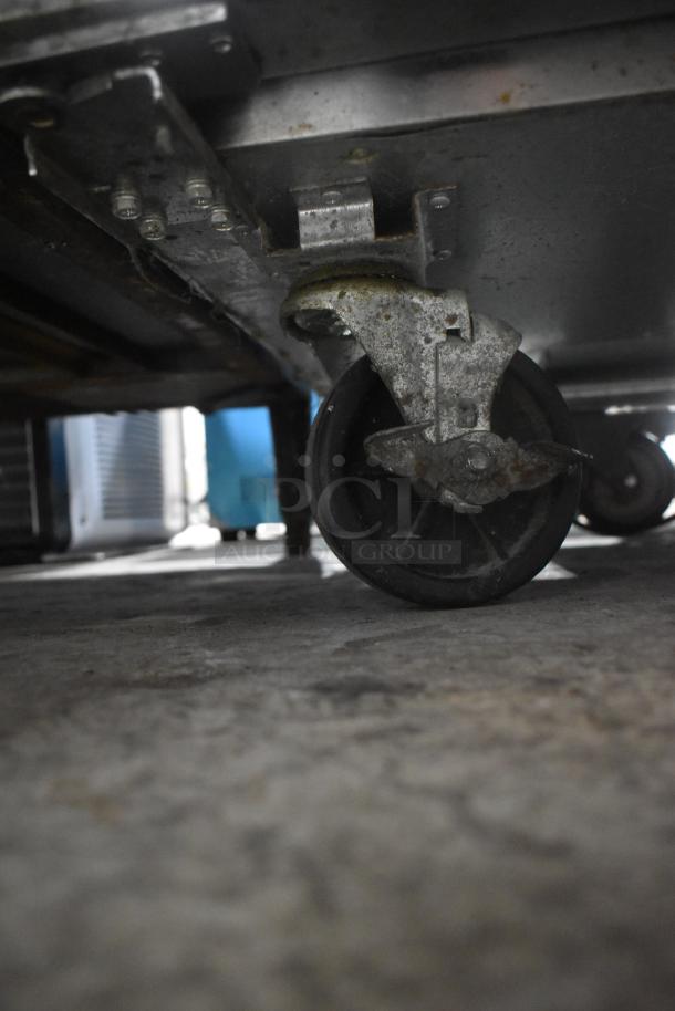 2020 Padela PDS-48-HC stainless steel prep table caster, showing rust and wear, on commercial casters.