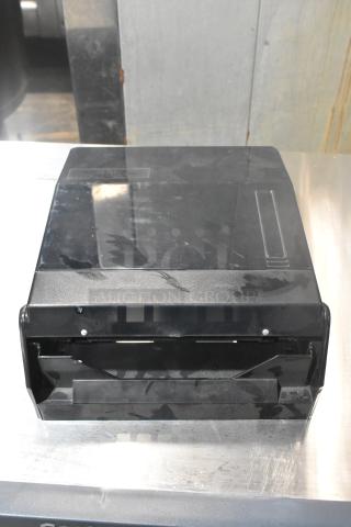 Black poly wall mount paper towel dispenser, model TD-MFOLD, in fair condition with visible surface scratches.