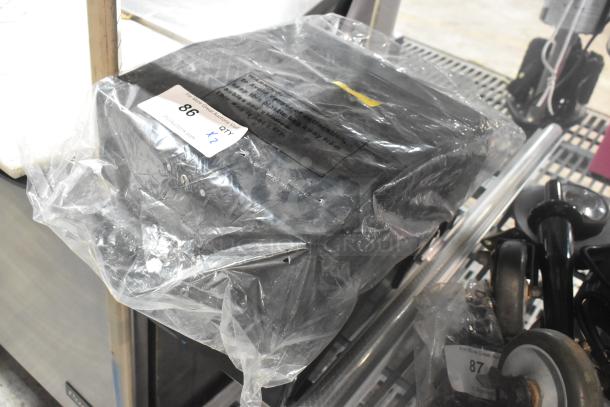 2 Update TD-MFOLD black poly wall mount paper towel dispensers in sealed packaging. Auction tag reads "86 QTY x2".