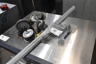 Lot of 7 items; includes 4 casters and a vacuum brush. Casters in used condition. Bag labeled "87" with parts.