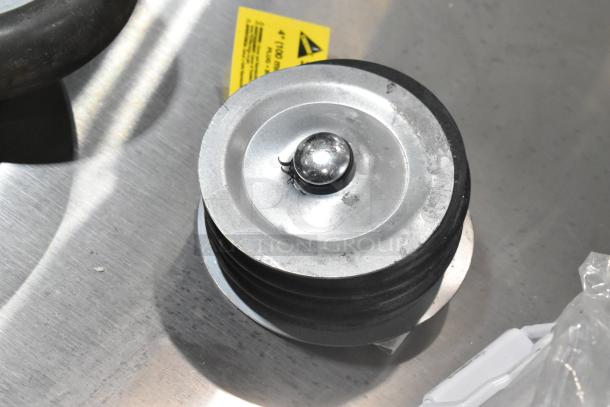 Lot of 7 items: Close-up of a metal caster with rubber wheel. Includes 4 casters, vacuum brush. Item shows slight wear.