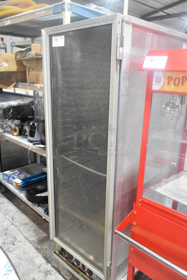 Omcan metal commercial heated holding cabinet with glass door, 115V, 1 phase, on casters, used condition.