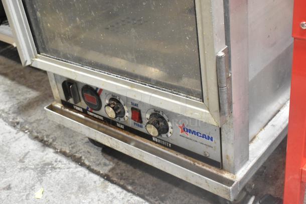 Omcan Metal Commercial Heated Holding Cabinet, 115V, 1 Phase, on casters. Visible controls for temperature and humidity.