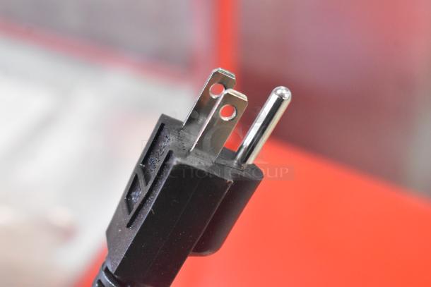 Close-up of a plug for the Carnival King 382PM30R Royalty Series 8 oz. commercial popcorn machine.