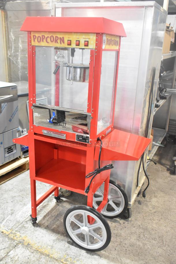 Brand new Carnival King 382PM30R 8 oz. red popcorn machine, scratch and dent condition, on a wheeled stand; 120 volts.