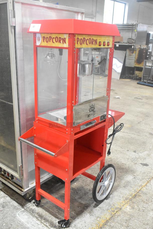 Carnival King 382PM30R red popcorn machine, new, on stand, 8 oz capacity, with "Popcorn" signage, 120V, 1 phase, commercial use.