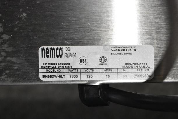 Nemco 8045SXW-SLT hot dog roller grill label; shows model, 1300 watts, 120 volts, 15 amps, made in USA, NSF, ETL markings.