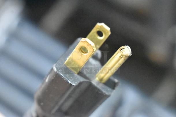 Close-up of gold prong plug for Nemco 8045SXW-SLT hot dog roller grill, showing minor wear detail.